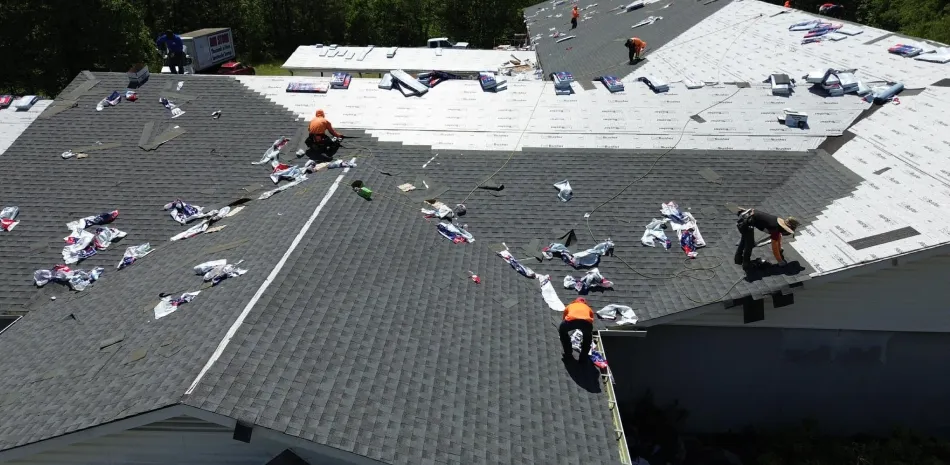 Workers replacing roofing on home in Mooresville, NC